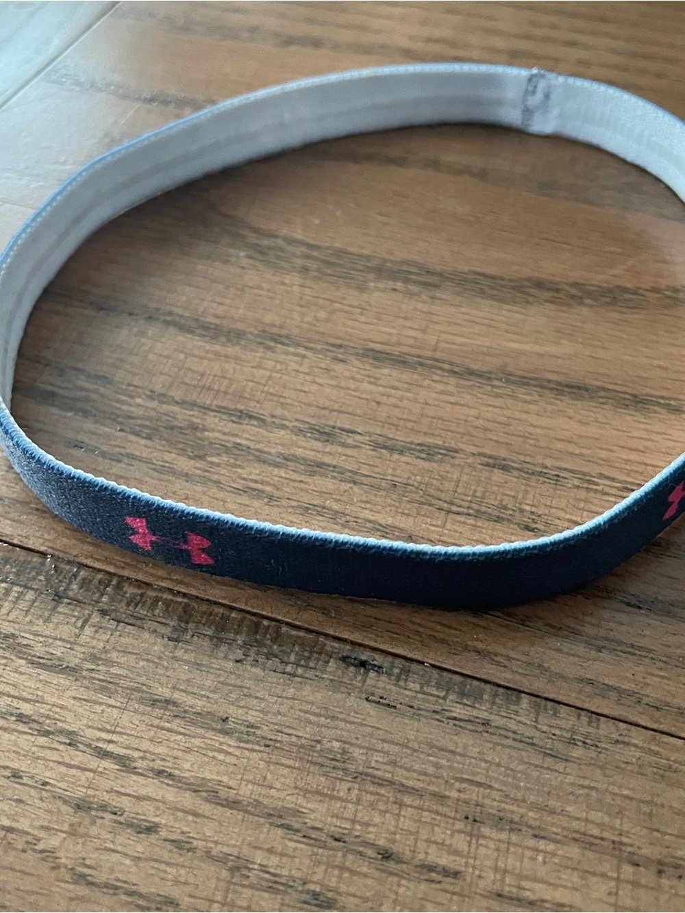 Under Armour navy blue stretchy headband with pink logo